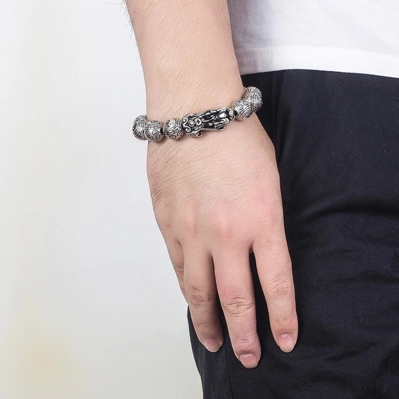 Pixiu bracelet worn on wrist with white shirt - casual professional setting