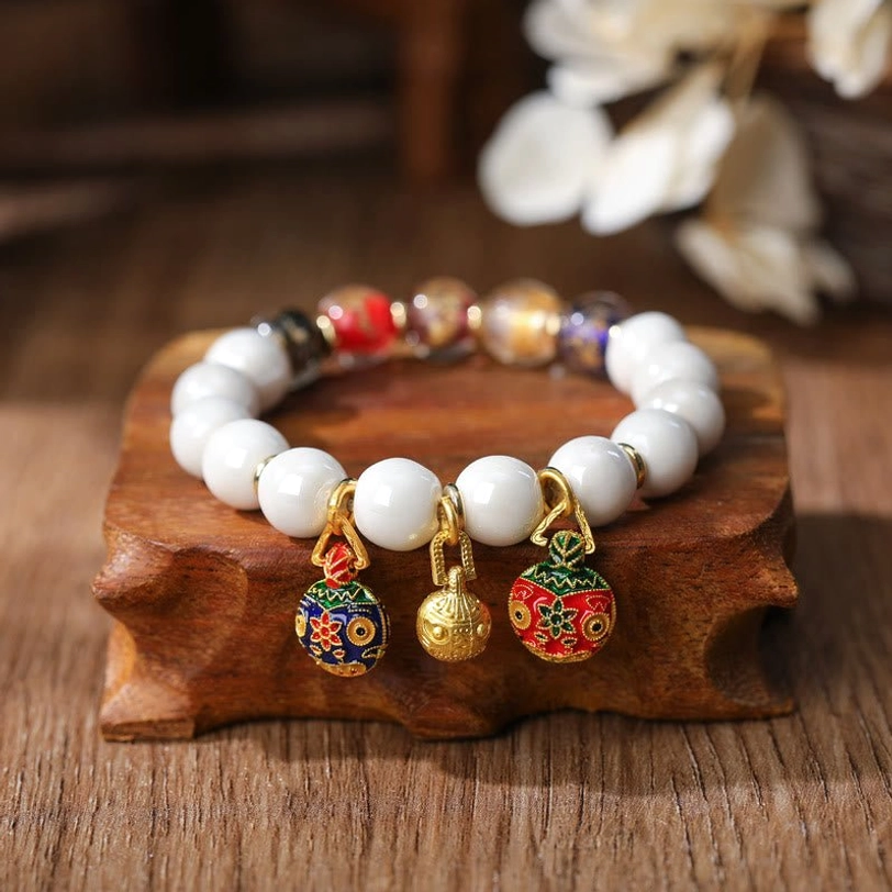 Gold Pixiu charm bracelet with multicolored gold silver foil beads and protective enamel charms close-up detail shot