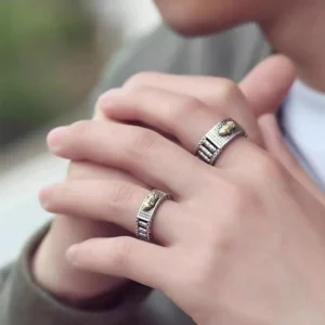 Couple wearing matching Pixiu wealth rings on different fingers, casual daily wear lifestyle shot