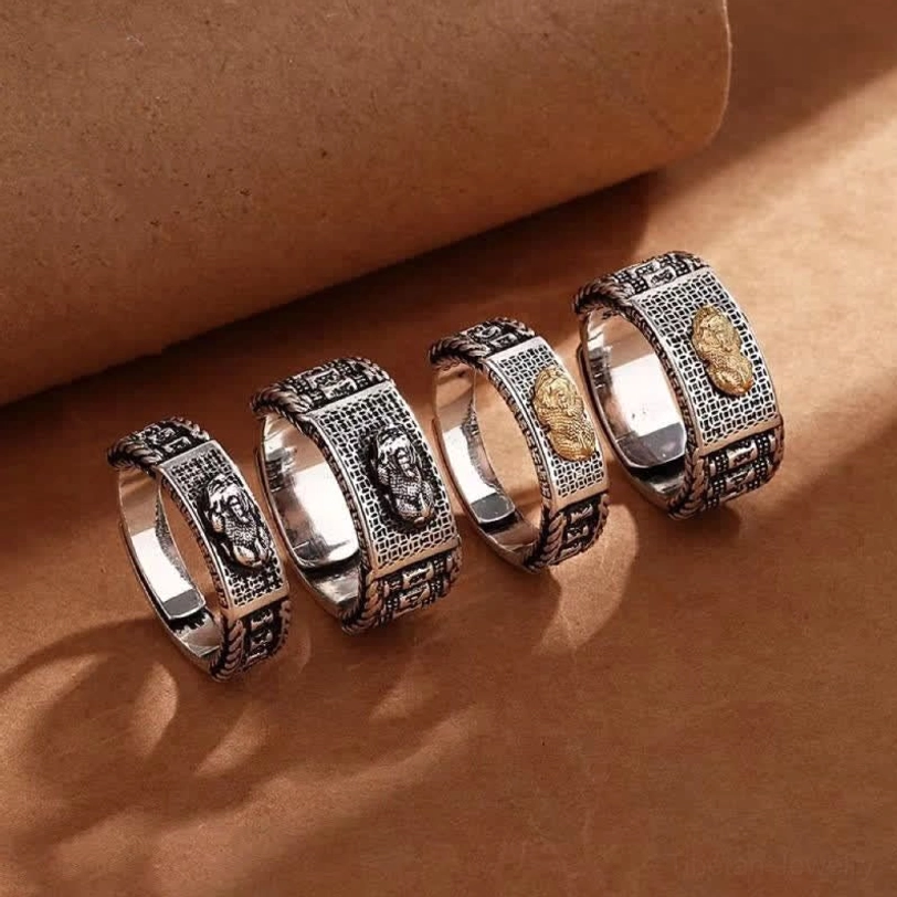Complete Pixiu couple ring set of four rings in mixed silver and gold styles displayed flat lay on kraft paper