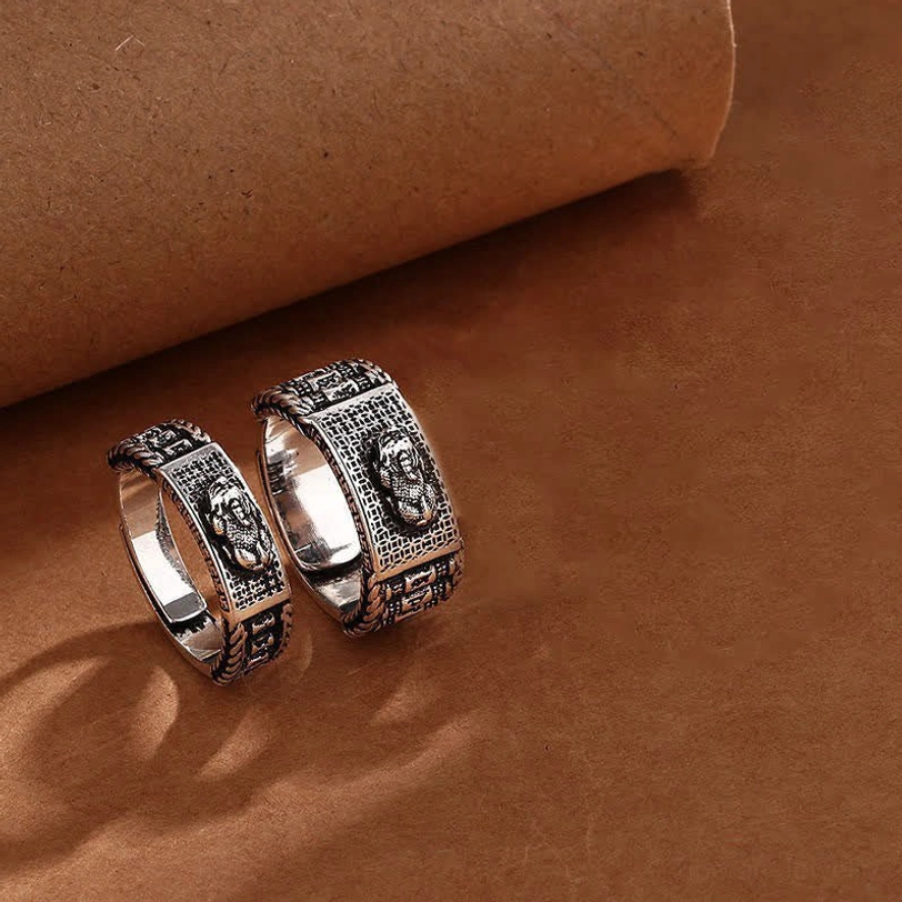 Two Pixiu couple rings in retro silver finish with distinct carved embossed details shown in flat lay composition