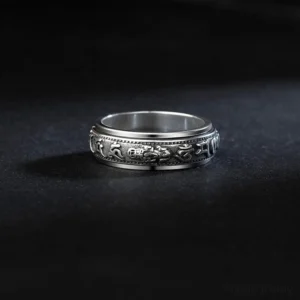 Top flat view of rotatable Pixiu mantra ring showing antique silver finish and carved religious patterns