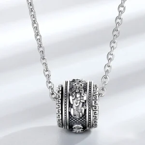 Close-up of Pixiu prosperity talisman pendant with vintage engraved details and curb link chain
