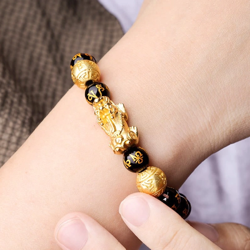 Feng Shui Pixiu wealth bracelet worn on wrist, showing detailed mantra beads and prosperity charm in daily wear scenario