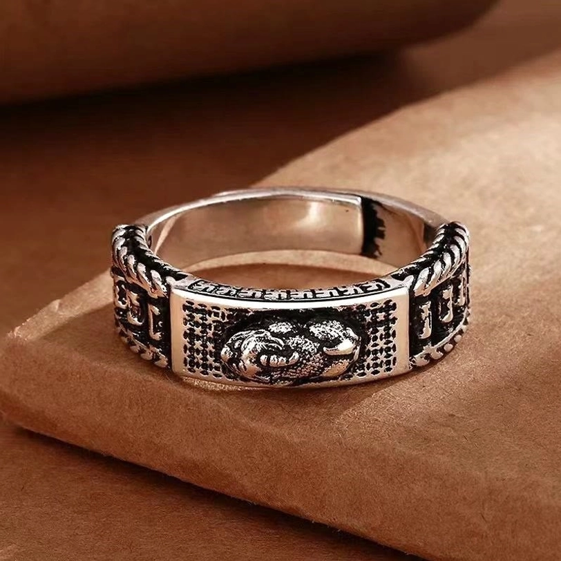 Pixiu prayer wheel ring front view showcasing central embossed Pixiu figure with rotating wheel and retro engraved patterns