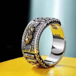 Pixiu wealth prayer wheel ring side-view close-up with embossed dragon design and S925 silver stamp on black display background