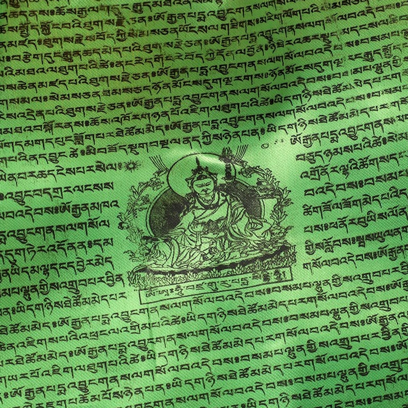 Single green prayer flag detailed view with sacred Tibetan scripture and Buddhist deity pattern
