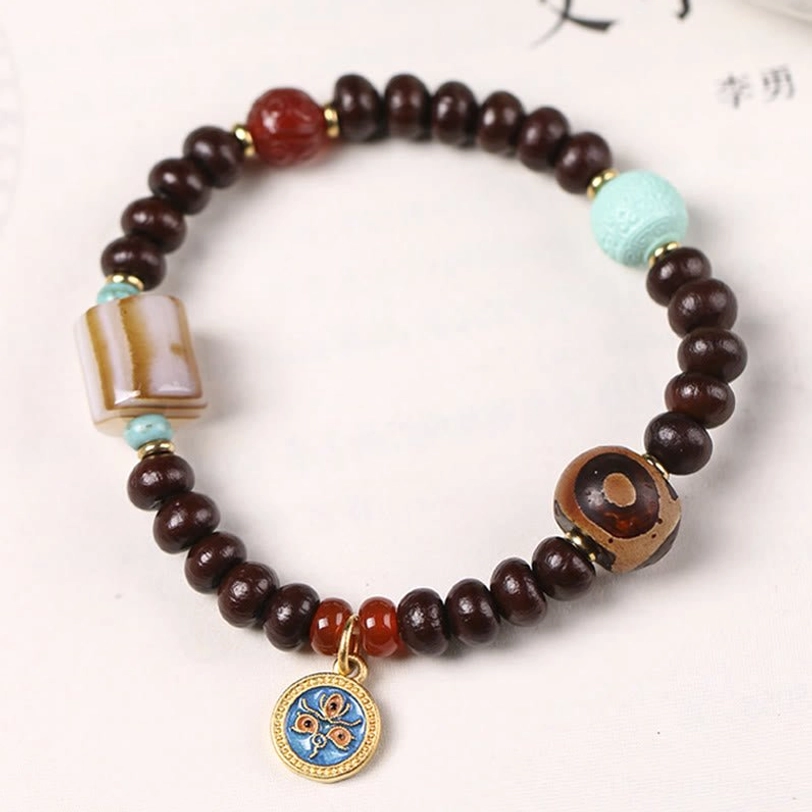 Purple bodhi seed Dzi bead bracelet with three-eye striped agate dzi, red agate beads, turquoise stone, and enamel pendant