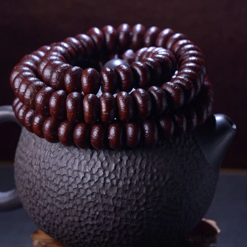 Coiled Purple Bodhi Seed mala bracelet displaying uniform dark red beads and neat bundled presentation