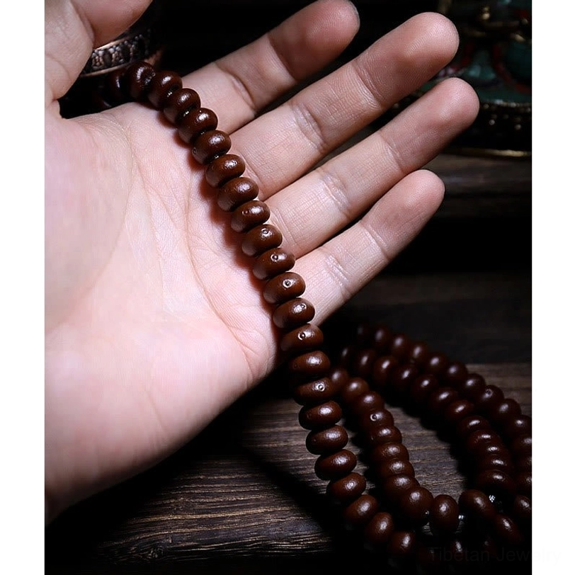 Purple bodhi seed prayer beads in Tibetan mala configuration with protective symbols