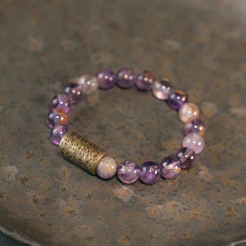 Purple phantom quartz healing bracelet in all available sizes, laid out flat showing size variations