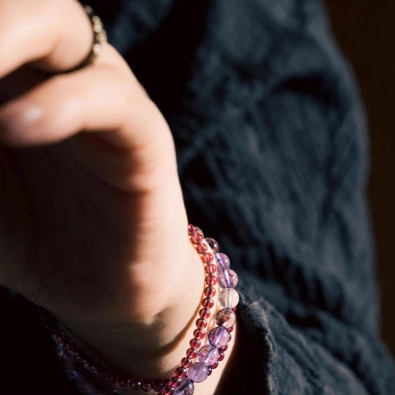 Amethyst garnet balance bracelet showing vibrant purple and red bead colors with metal accent