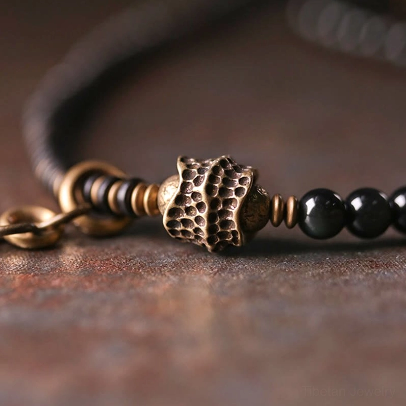 Rainbow obsidian multilayer bracelet focal section with embossed bronze metal spacer bead and black obsidian beads