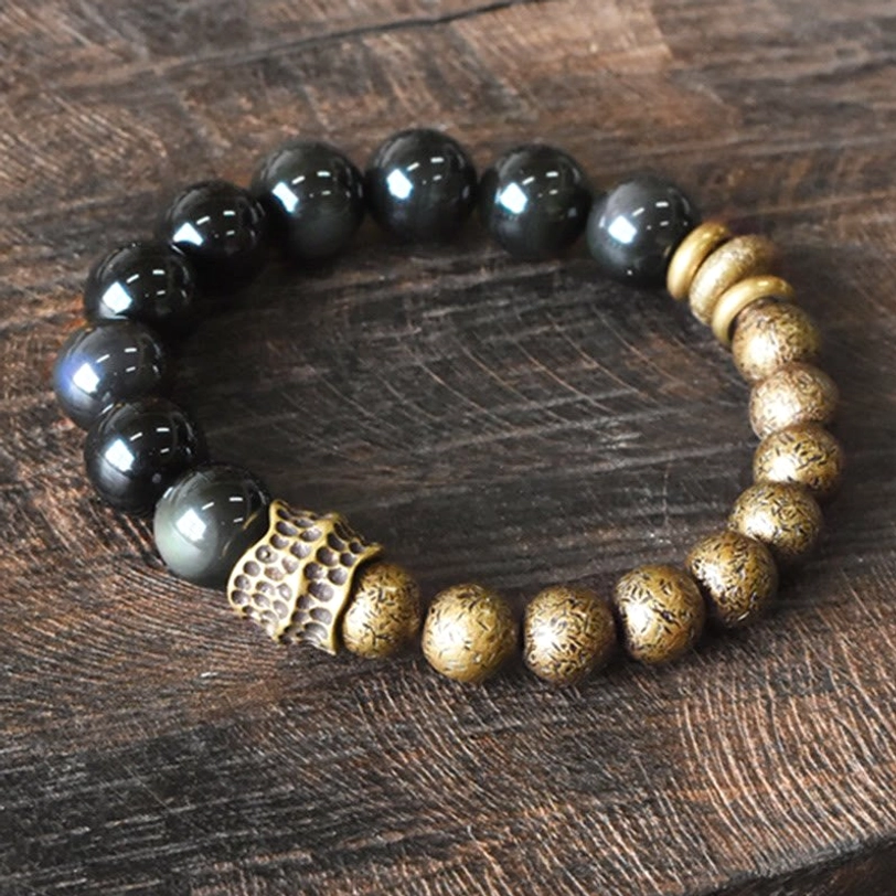 Rainbow Obsidian Copper Beaded Bracelet - Top View Flat Lay Showing Glossy Black Obsidian Beads with Vintage Bronze Metal Accents and Carved Connector
