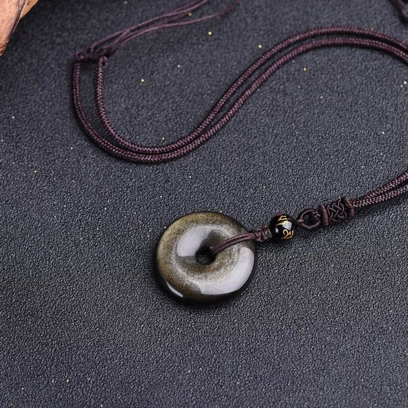 Rainbow obsidian protection necklace in bright light showing iridescent rainbow hues beneath black surface