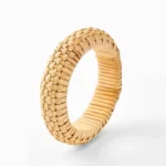 Hand-woven rattan grounding bracelet flat lay front view with checkerboard woven texture and natural tan color on white background