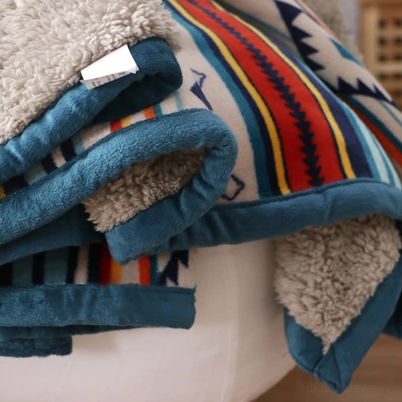 Tibetan-inspired throw blanket draped elegantly over reading chair in minimalist living room with geometric aztec pattern detail