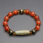 Red agate nine-eye dzi bead bracelet with om mani padme hum spacer beads, flat lay top-down view showing round polished red agate stones and black engraved prayer spacers