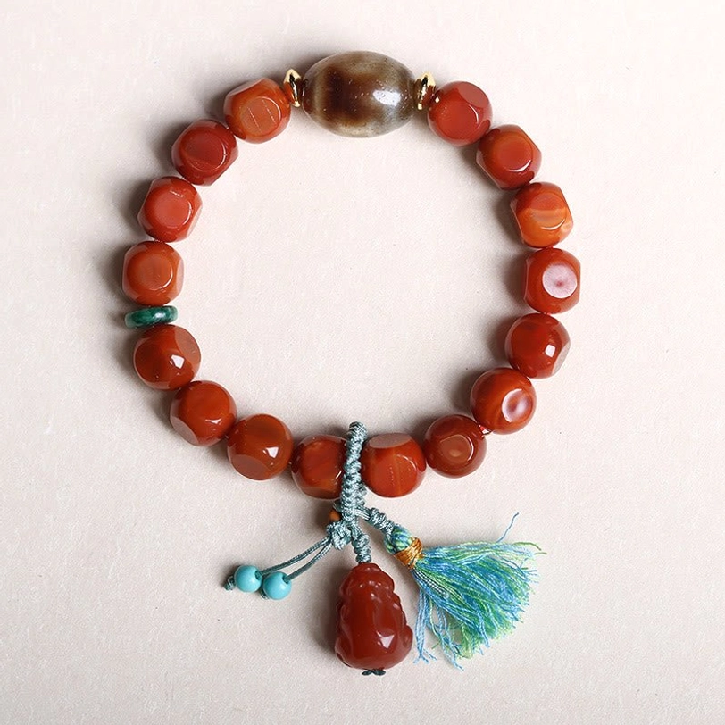 South Red Agate Pixiu Fortune Bracelet - Smooth Red Agate Beads with Blue Accent Spacers, Turquoise Tassel and Pixiu Charm on White Background