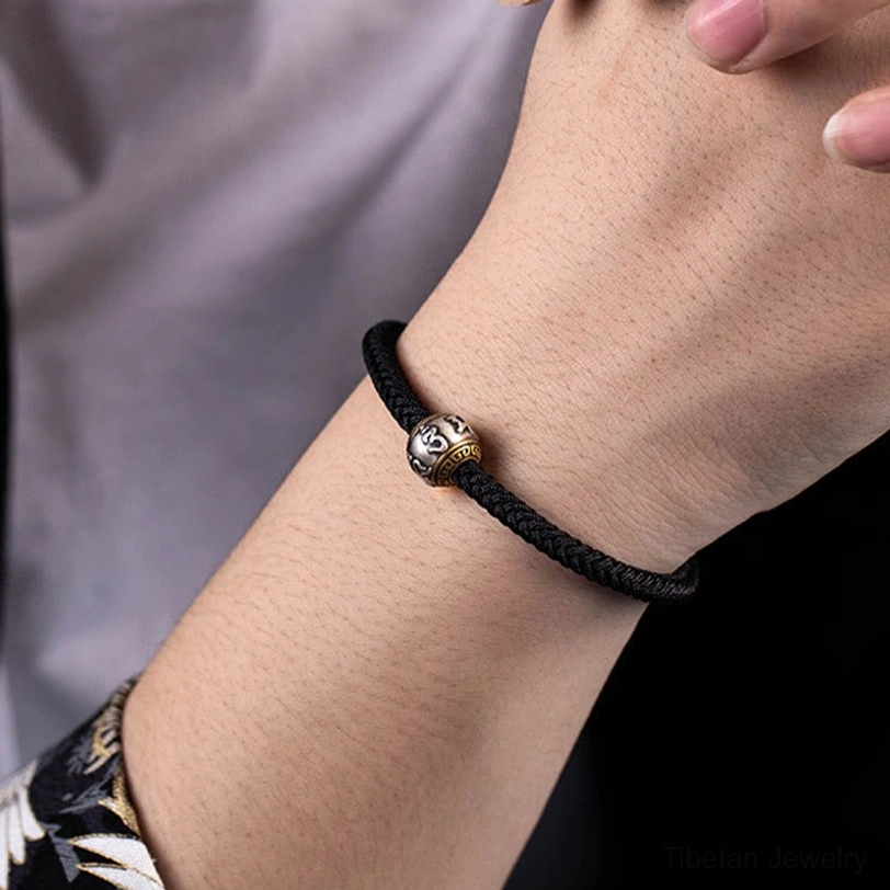 Red Om Mani Padme Hum Tibetan bracelet highlighting woven rope and adjustable fit
