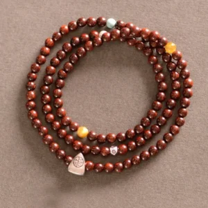 Red sandalwood small leaf triple wrap bracelet with sterling silver Fu character charm and mixed accent beads - top view flat lay
