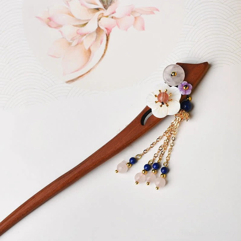 Flat lay view of red sandalwood hairpin with round stone bead and simple chain tassel