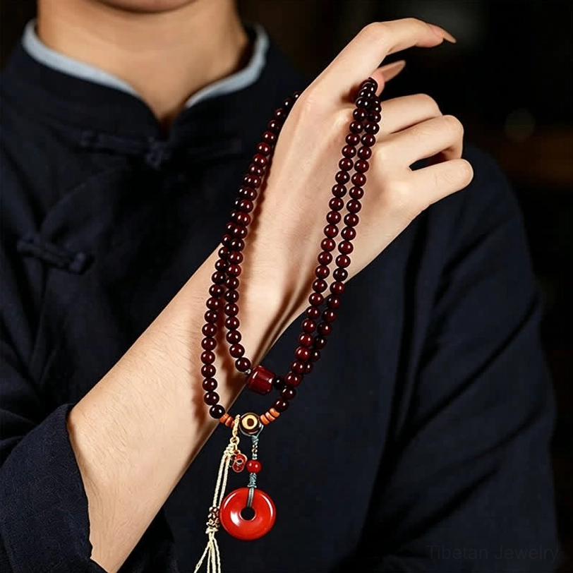 Red sandalwood 108 bead mala prayer necklace featuring peace buckle charm and natural wood bead craftsmanship