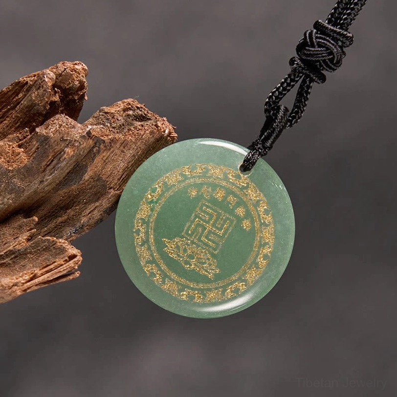 Red stone Buddhist pendant necklace front view on dark leather background