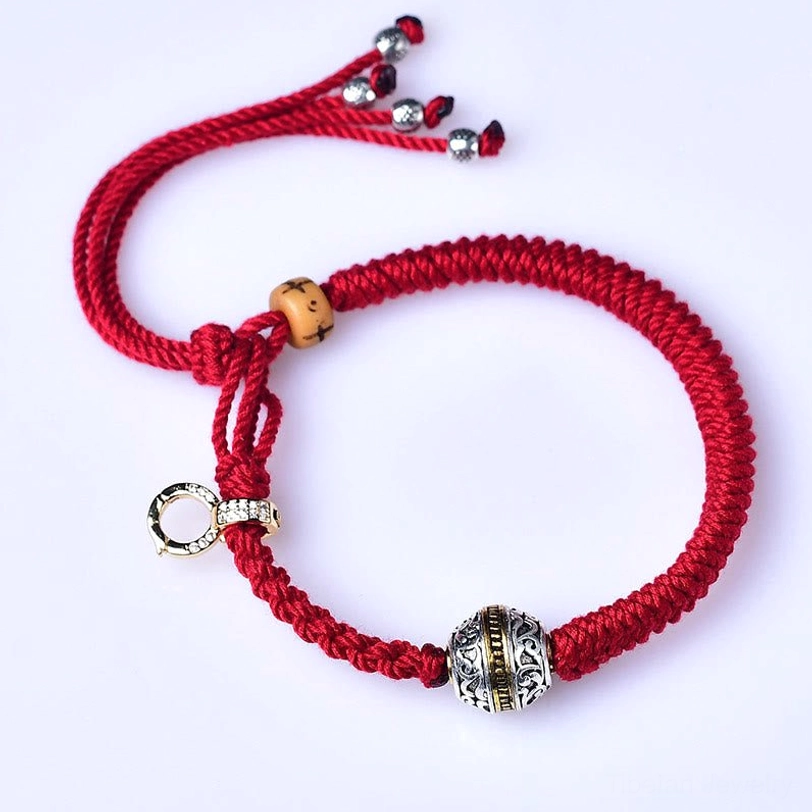 Red braided fortune bracelet front view with crystal-embedded gold clasp and wooden bead