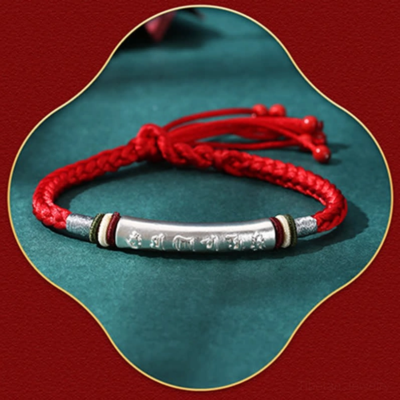 Single red string silver bracelet with engraved Om Mani Padme Hum tube and adjustable tassel closure
