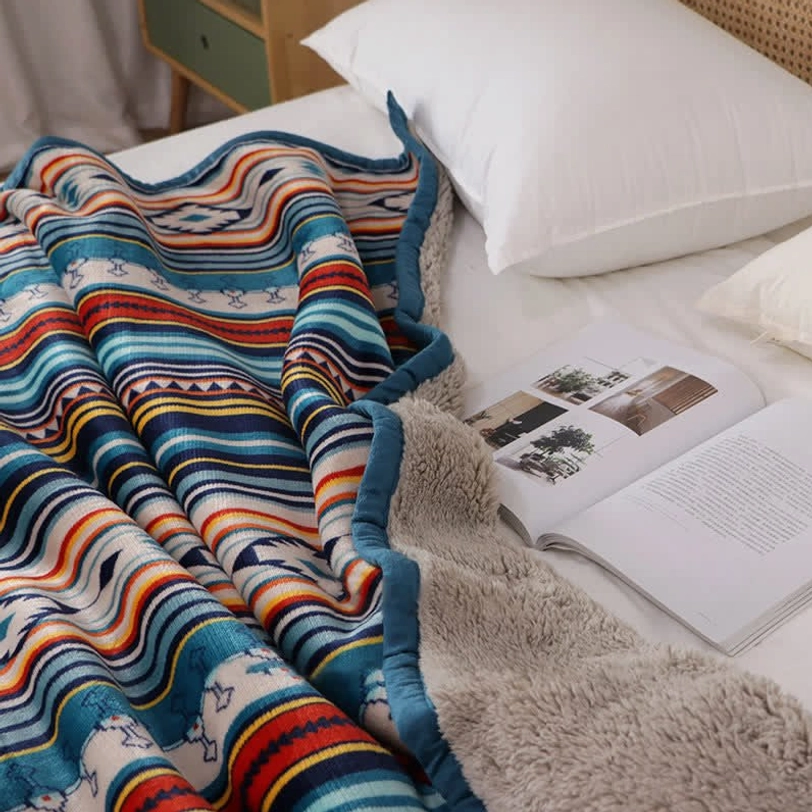 Reversible geometric throw blanket showing both sides—vibrant tribal print front and cozy sherpa fleece back for dual aesthetics