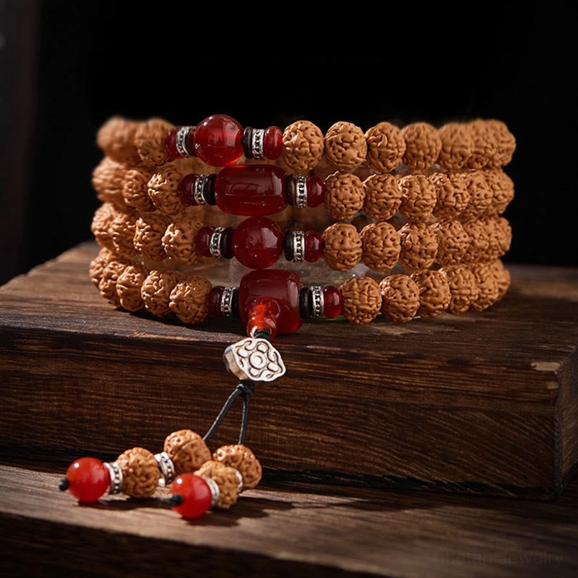 Rising sun style three-eye dzi bodhi mala with 10mm beads, showing protective amulet design and traditional Tibetan spiritual jewelry