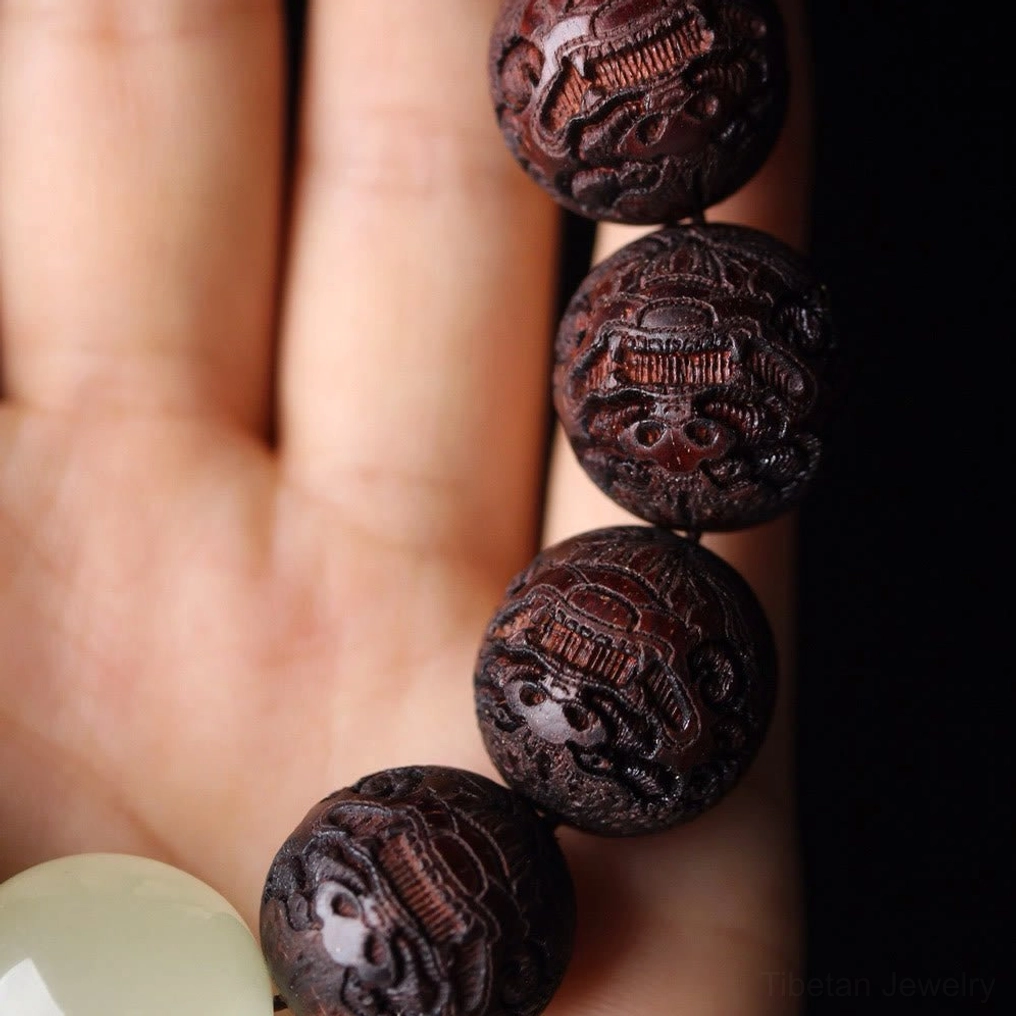 Rosewood Pixiu beaded bracelet on human hand side view with multiple jade spacer beads