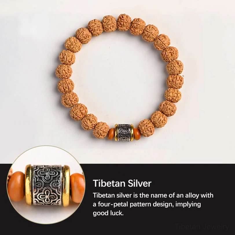Spiritual Rudraksha Bodhi seed bracelet with four-petal pattern Tibetan silver barrel and orange accents