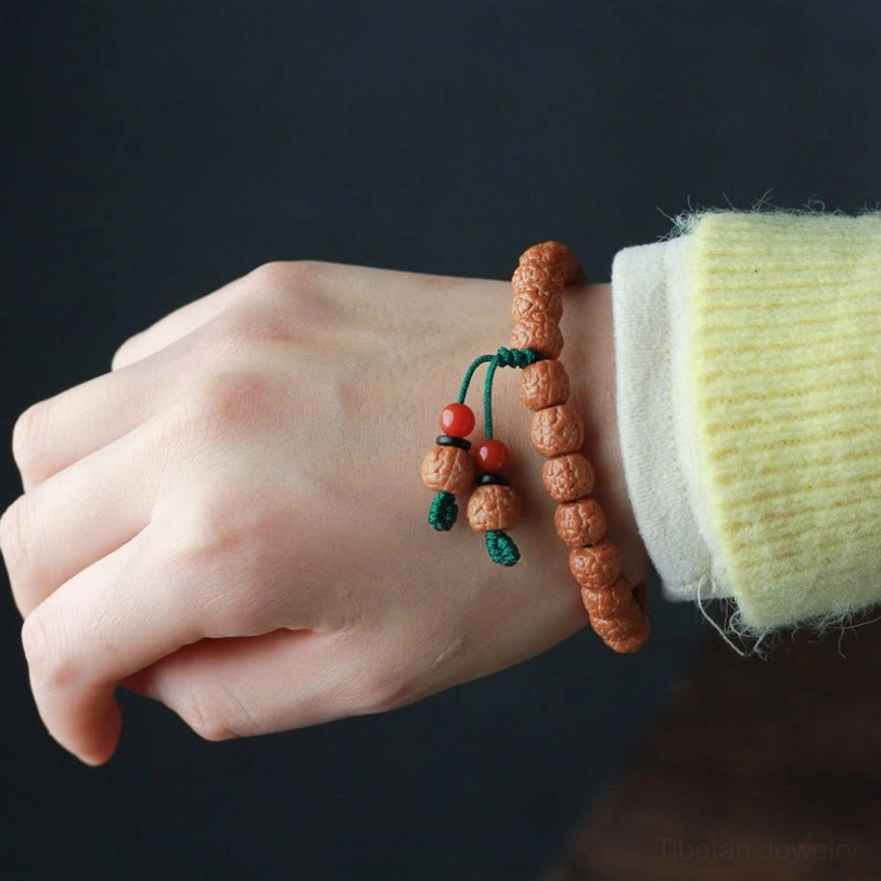 Wearing rudraksha bodhi seed bracelet on wrist with knitted sleeve detail