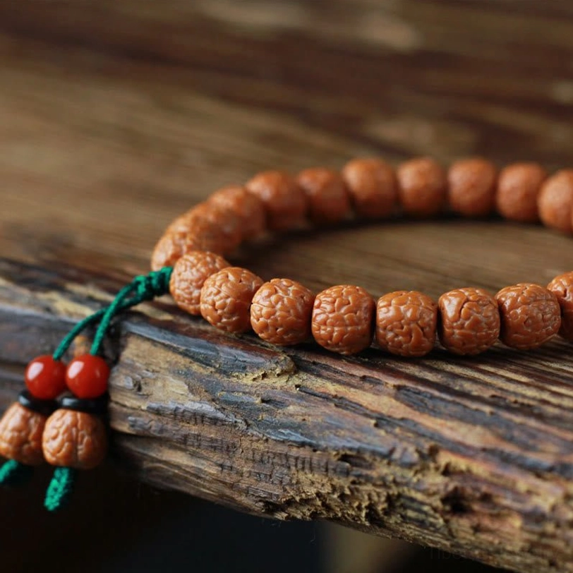 Rudraksha bodhi seed wealth bracelet on wooden surface showing authentic handmade craftsmanship