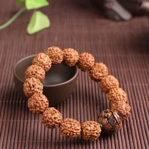 Rudraksha Pixiu prosperity bracelet displayed on bamboo mat with ceramic bowl, natural lighting warm tones