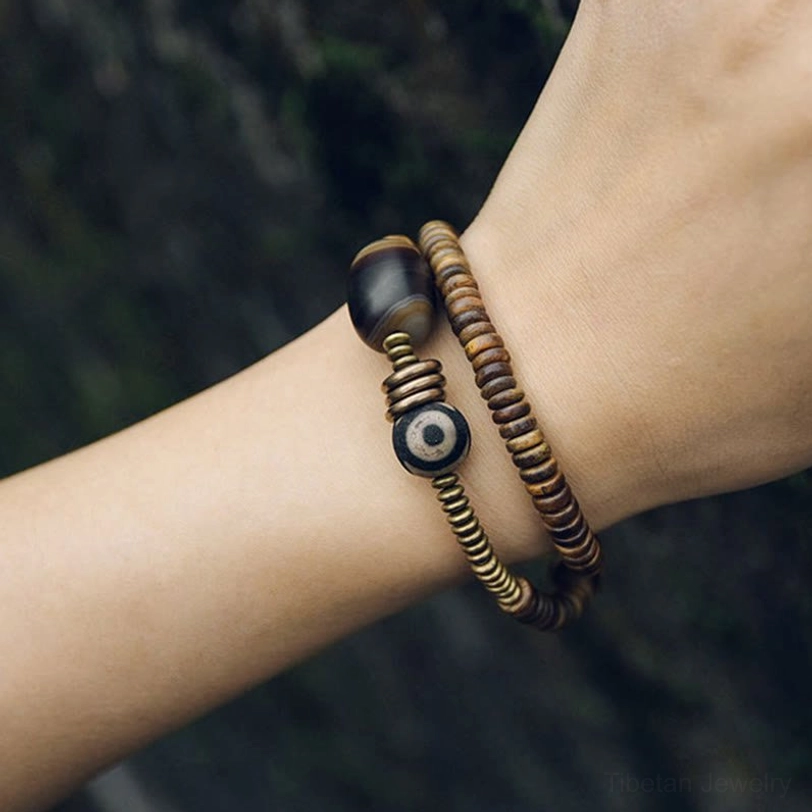 Sacred Dzi bead bracelet with natural ebony wood and spiritual grounding properties