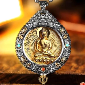 Sakyamuni Buddha guardian pendant with turquoise and coral inlay on warm wooden background