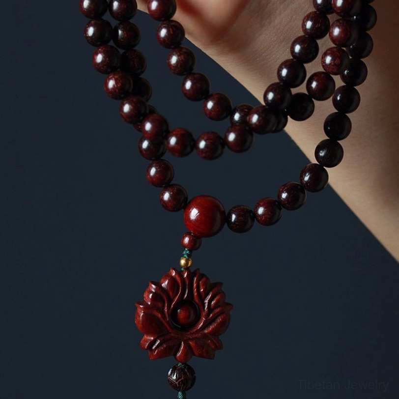 Red sandalwood lotus mala necklace side hanging view showing polished round beads and carved lotus pendant detail