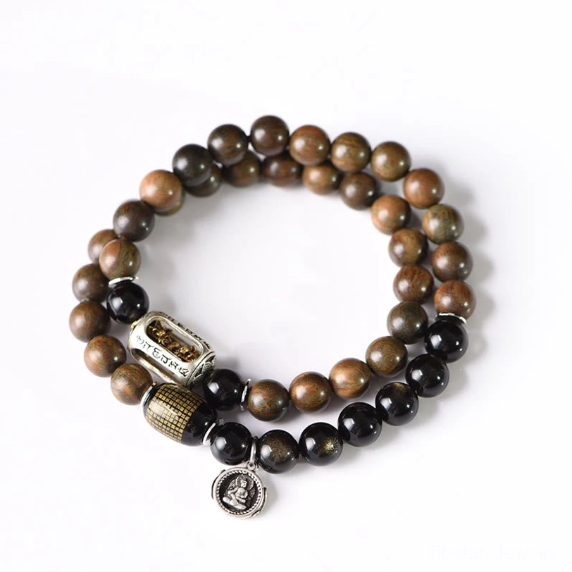 Green sandalwood gold sheen obsidian bracelet artistic flat lay styling composition