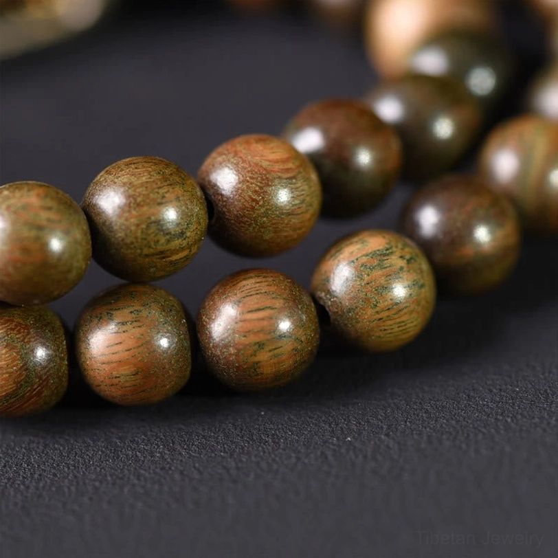 Green sandalwood gold sheen obsidian double wrap bracelet worn on wrist lifestyle