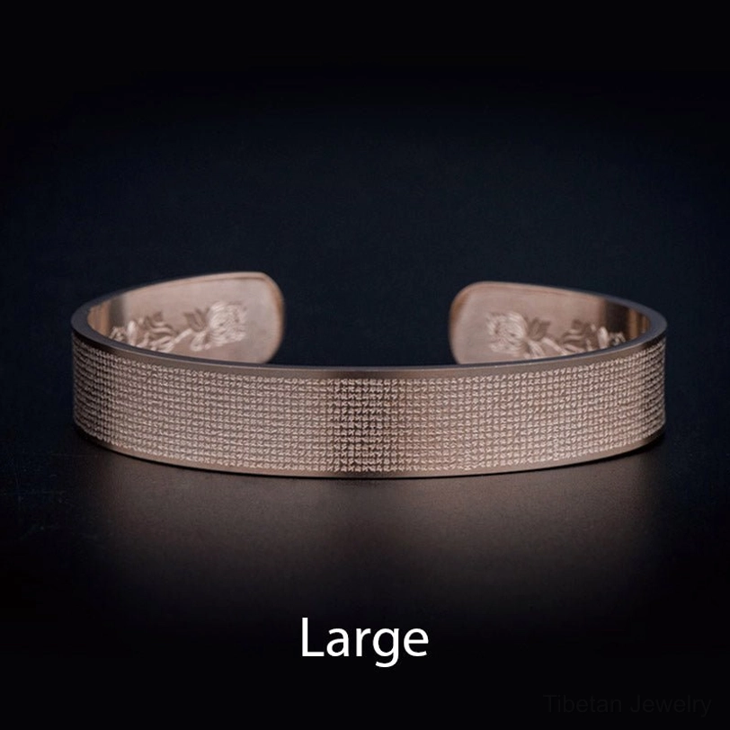 Large Shurangama mantra titanium steel bracelet in peachpuff color - overhead studio view showing full engraved surface