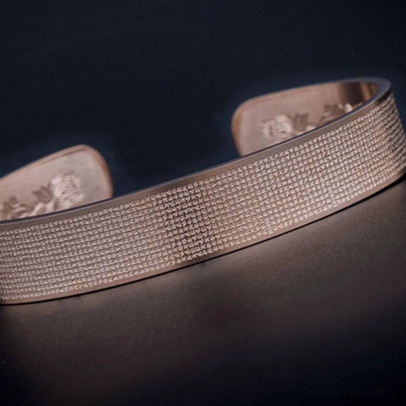 Shurangama mantra titanium steel bracelet in peachpuff finish - product detail photography of sacred engraving