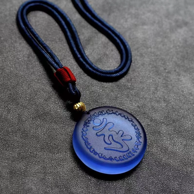 Shurangama Mantra crystal pendant necklace alternate angle view showcasing red woven cord knot detail and gold spacer bead with engraved mantra