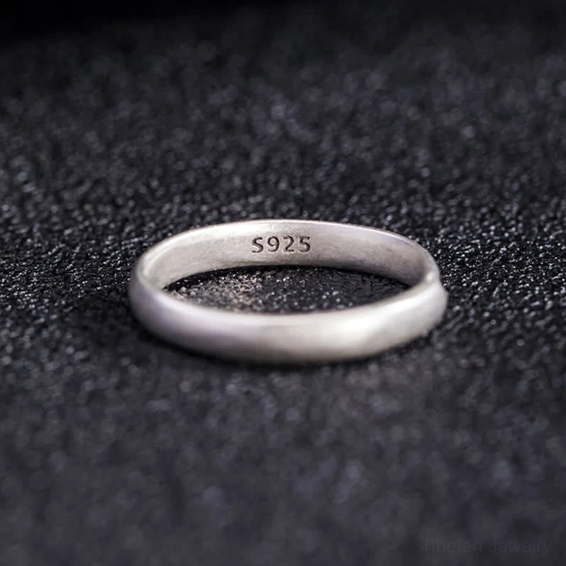 Interior top-down view of 925 sterling silver lotus ring showing S925 hallmark stamp and engraved lotus on outer band