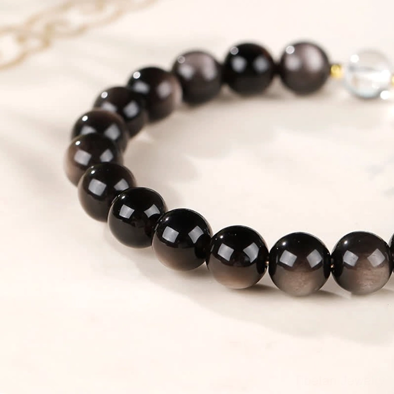 Silver Sheen Obsidian Dzi Bead Bracelet showing elastic string quality and bead spacing
