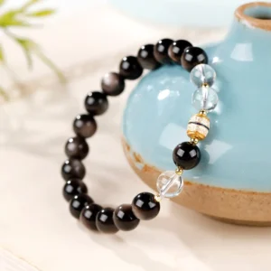 Silver Sheen Obsidian Dzi Bead Protection Bracelet side angle showing texture and bead arrangement