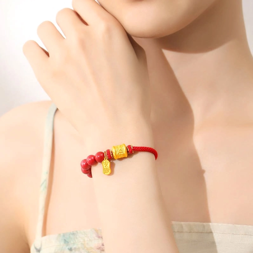 Fashion wearable cinnabar blessing bracelet on female model hand showing delicate slim fit design with gold pendant