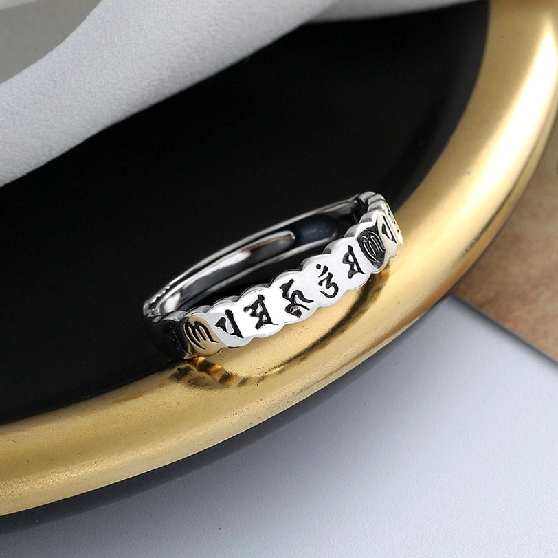 Six true words mantra ring close-up, detailed Sanskrit engravings on sterling silver with scalloped vintage band edges